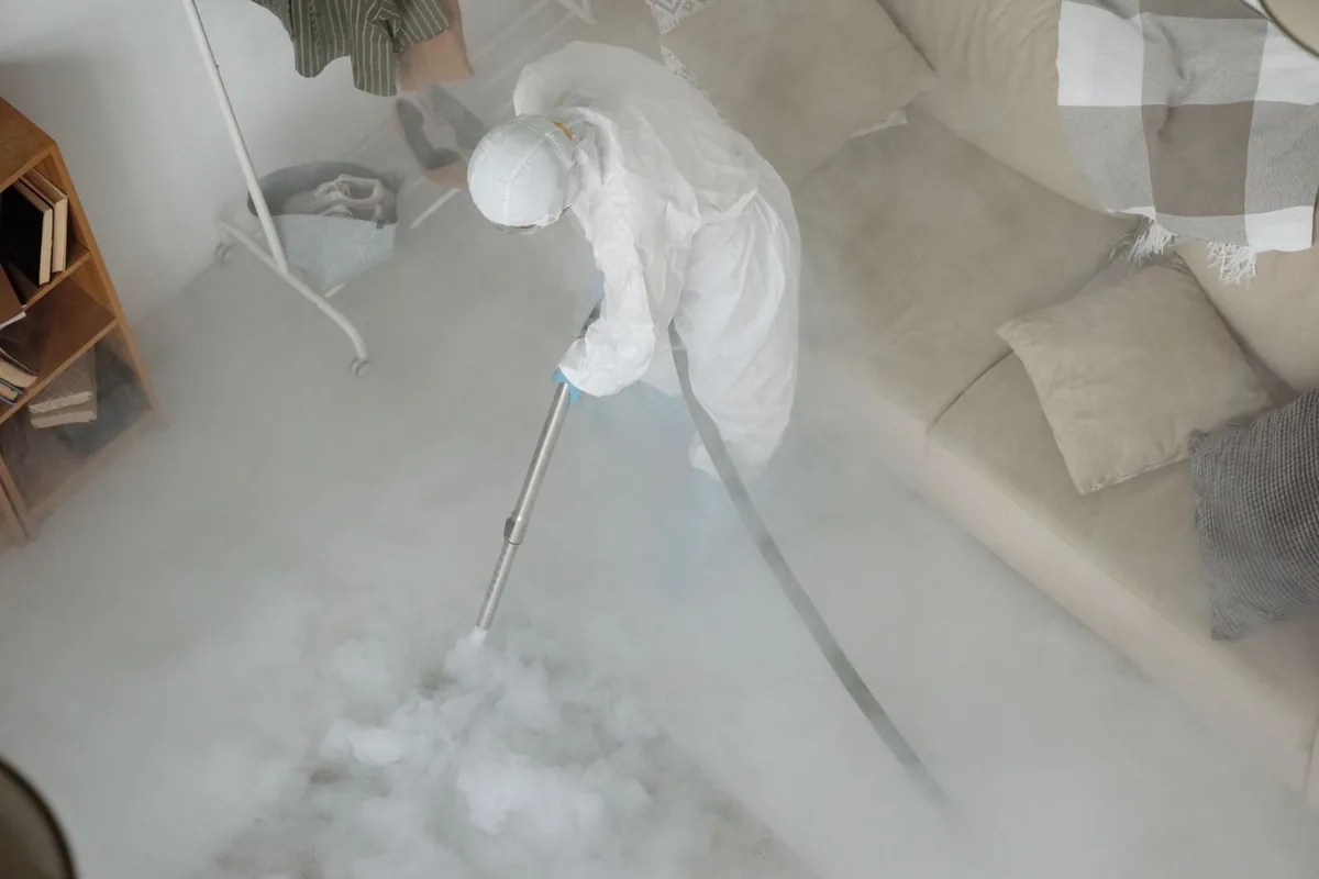 Biohazard cleanup technician in protective equipment, Bridgeport, NY